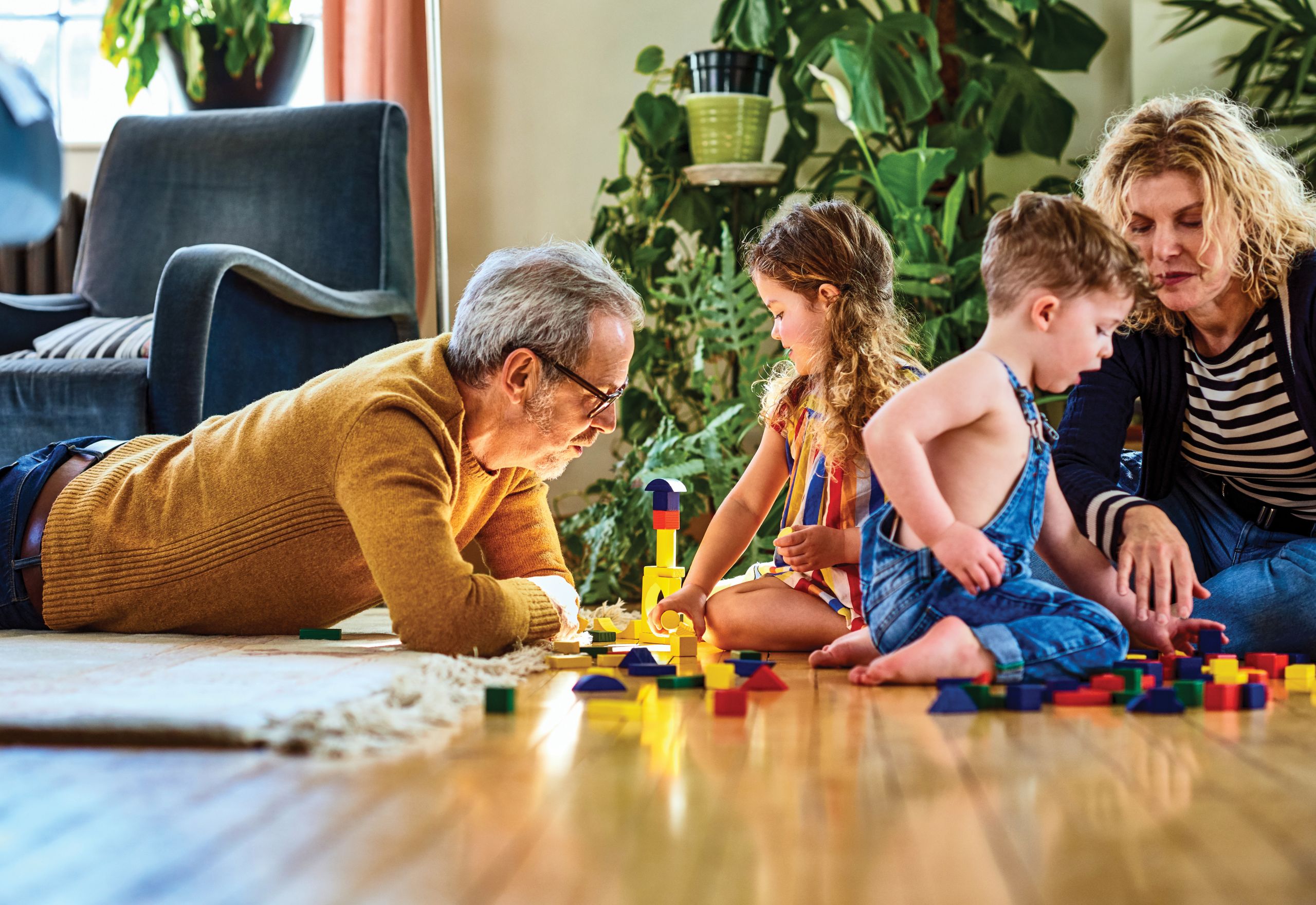 Children playing with blocks while their parents supervise